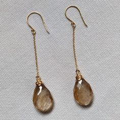 **KINDLY CHECK OUT THE VIDEO OF THE ITEM FOR A CLEARER VIEW**Details of the earrings Gemstone : Golden Rutilated quartz Gemstone weight: 17.09 carats Gemstone shape and size: pear , 18x12 mm Metal: GOLD Purity: 14K Gold Weight: 1.12 grams Total weight: 4.54 grams Natural golden rutile gemstones set in solid 14k yellow gold studs. The Gold purity is absolutely guaranteed and it comes with an authentic 14 k gold hallmark. Since these earrings are handmade, Gemstone customization is available and t 14k Gold Briolette Jewelry With Matching Earrings, Briolette Fine Jewelry Earrings, Yellow Gold Gemstone Dangle Earrings, Faceted Long Drop Jewelry For Anniversary, Gold Briolette Earrings, Pierced, 14k Gold Briolette Earrings Gift, Gold Faceted Earrings For Anniversary, Gold Briolette Earrings, Yellow Gold Faceted Briolette Earrings