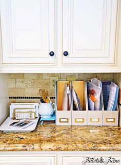 the kitchen counter is clean and organized with file folders, scissors, and other office supplies