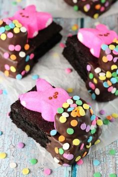 chocolate brownies with pink frosting and sprinkles