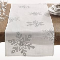 a white table runner with snowflakes on it