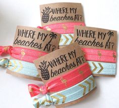 four bracelets with pineapple designs and words on them are sitting next to each other