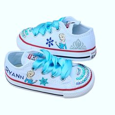 "These shoes have it all! Her name in glittery blue, Elsa on each shoe, sparkly snowflakes and a silver crown. If you choose the \"bling toes\", they have crystals in silver, royal blue and light blue and pearls too. Light blue satin ribbons in place of regular laces. Please know the correct size needed for your little one in Converse, they run big. Leave her name in the personalization box during check out. Want to change colors on anything? I can do it! Simply let me know what changes to make Bling Toes, Snowflake Shoes, Elsa Shoes, Frozen Shoes, Bling Converse, 4 Birthday, Themed Food, Bling Crafts, Frozen Themed