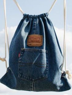 a blue jean bag hanging from a rope