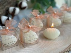 small candles with bows on them sitting on a table