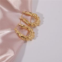 The Roxy Hoop Earrings exudes elegance in all ways. Perfect for any event you can think of, these earrings are ones you'll want to reach for over and over. Details: 1 8k Gold Plated Stainless Steel Dimensions: 20.17 mm x 26.72 mm Classic Metal Hoop Earrings For Party, Gold Plated Clip-on Hoop Earrings, Gold Plated Hoop Earrings With Ear Wire For Parties, Clip-on Hoop Earrings For Party, Small Hoop Gold Plated Earrings For Party, Tarnish Resistant Small Hoop Earrings For Party, Small Gold-plated Clip-on Hoop Earrings, Small Clip-on Gold Plated Hoop Earrings, Clip-on Hoop Earrings