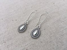 "Silver boho teardrop earrings. Made from allergy free plated silver. The little charms measure 5/8\" long by 3/8\" wide and hanging from 1\" long kidney style earring wires. If you would like a bigger version of this style, I have them also available in my shop. Here is the link. https://www.etsy.com/listing/589067627/silver-bohemian-drop-earrings-silver?ref=shop_home_active_1 Perfect for everyday, year round wear. They would make a perfect little gift or go ahead and treat yourself! Tiger Flow Bohemian Teardrop Earrings With Matching Pair, Teardrop Earrings For Festival, Festival Teardrop Earrings, Festival Teardrop Earrings With Ear Wire, Nickel Free Teardrop Earrings For Festival, Nickel-free Teardrop Earrings For Festival, Huge Pearl Necklace, Dainty Dangle Earrings, Silver Boho Jewelry