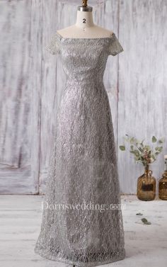 a dress on a mannequin with flowers in the background