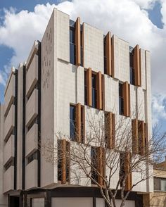 a tall building with wooden shutters on the front and side of it's face