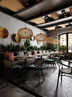 a restaurant with tables, chairs and plants on the wall above them is an indoor dining area