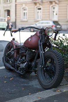 an old motorcycle is parked on the side of the road