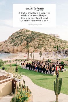 a wedding ceremony in front of the ocean and mountains with guests standing on the lawn