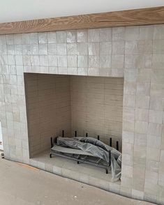 a room with a fireplace that is being built into the wall and covered in plastic