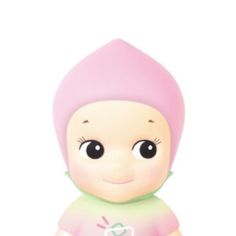 a small doll with a pink hat on it's head and eyes, sitting in front of a white background