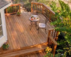 a table and chairs on a wooden deck