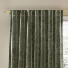 a green curtain hanging in front of a window