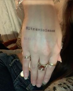 a woman's left hand with the word love written on it