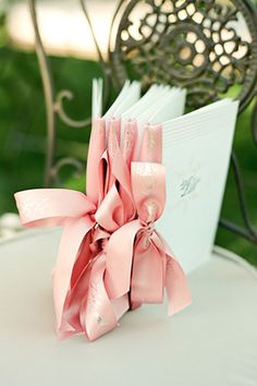 a close up of a book on a chair with a ribbon tied around the book