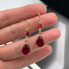 Red Drop Jewelry With Matching Earrings, Red Ruby Drop Jewelry, Elegant Red Drop Crystal Earrings, Red Drop Crystal Earrings As Gift, Formal Red Pear-shaped Earrings, Red Pear-shaped Earrings For Formal Occasions, Elegant Red Crystal Earrings, Red Drop Earrings For Pierced Ears, Red Teardrop Earrings For Formal Occasions