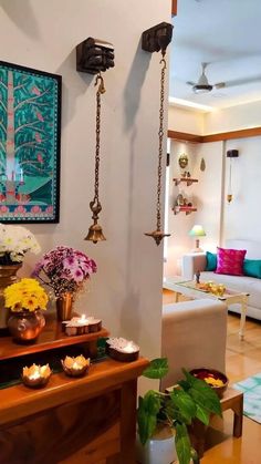 a living room filled with lots of furniture and flowers on top of a wooden table