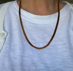 This classic 1990s Monet herringbone necklace measures 22 inches and is gold-plated with a sleek, shiny finish. It is in excellent condition, complete with its original hang tag. The herringbone design adds a timeless and sophisticated touch, making it a versatile piece for both casual and formal wear. Monet Jewelry, founded in 1937, is known for its high-quality costume jewelry that mimics fine jewelry trends. The brand became renowned for its elegant and affordable designs, often plated in gol Herringbone Design, Herringbone Chain, Herringbone Necklace, Monet Jewelry, Jewelry Trends, Formal Wear, Herringbone, Costume Jewelry, Chains Necklace