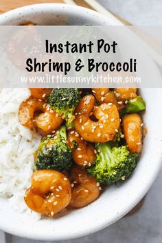 a white bowl filled with shrimp and broccoli on top of rice covered in sesame seeds