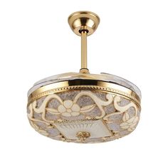 an ornately decorated ceiling light in gold and white with flowers on the glass shade