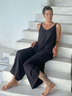 Cotton Ruched JumperOur loose-fitting lounge-ready jumpsuit is made from 100% cotton and will keep you cool and comfy on hot summer days. Adjust the wide legs by ruching them or wear them full-length. Layer one of our crop tops under it for extra style. We recommend hang-drying our 100% cotton. ColorsThis jumper is available in these colors: Matcha Camel Mangosteen Pacific Black Carbon Features: Adjustable shoulder straps Can be worn full or ruched to capri length Side pockets Size Suggestions: Comfortable Summer Loungewear Jumpsuits And Rompers, Comfortable Summer Loungewear Jumpsuits, Comfortable Summer Jumpsuits And Rompers For Loungewear, Cotton Loungewear Jumpsuits And Rompers, Solid Cotton Jumpsuits And Rompers For Loungewear, Cotton Jumpsuits And Rompers For Summer Lounging, Comfortable Solid Cotton Jumpsuits And Rompers, Comfortable Cotton Solid Color Jumpsuits And Rompers, Cotton Jumpsuits And Rompers For Spring Lounging