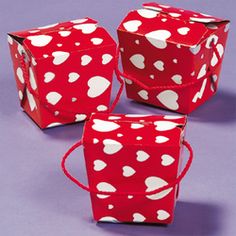 three red boxes with white hearts on them