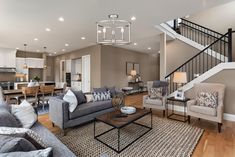 a living room filled with furniture and a stair case