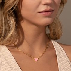 Our best-selling heart necklace, featuring a paperclip chain, now comes in even more colors! This chain and pendant necklace is a sweet addition to your daily necklace set. For a full look, layer the Enamel Heart Necklace in the color of your choice with your favorite gold chain necklaces. Please note that the off white color has pink undertones and in certain lighting it may look more pink than white. Pink Charm Necklaces For Everyday Wear, Pink Charm Necklace For Everyday, Trendy Heart-shaped Everyday Chain Necklace, Trendy Everyday Heart-shaped Chain Necklace, Everyday Pink Charm Necklaces, Trendy Everyday Heart Necklace With Delicate Chain, Trendy Everyday Chain Necklace With Heart Charm, Trendy Chain Necklace With Heart Charm For Everyday, Dainty Heart Charm Necklace With Paperclip Chain