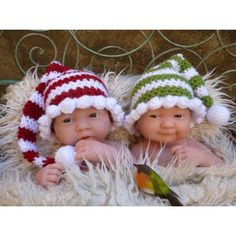 two baby dolls wearing knitted hats and scarves