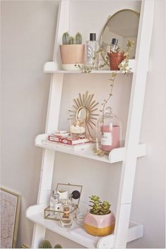 a white shelf filled with lots of different types of items on top of each other