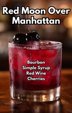 the red moon over manhattan cocktail is garnished with cherries