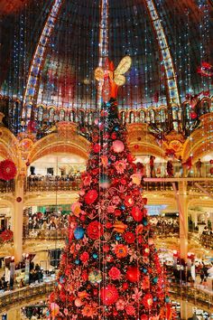 a large christmas tree in the middle of a mall