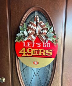 a football themed door hanger that says let's go fortyers on it