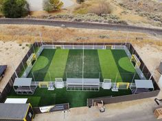 an aerial view of a soccer field with benches