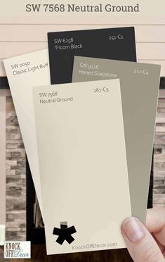 someone holding up some paint swatches in their hand with the words sw 758 neutral ground