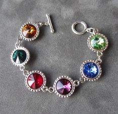 "Custom Mother's bracelet in silver with Swarovski Crystal birthstones. This sparkling birthstone bracelet would make a perfect gift for a mother or grandmother, with Swarovski crystals, set in luxurious rhodium plate, representing the birthstones of their family members. This listing is for a bracelet with six birthstones, it's available with fewer birthstones as well as in gold here: http://www.etsy.com/shop/SprigJewelry?section_id=12452545 <>How to Order<> At checkout, please spec Mothers Birthstone Bracelet, Grandma Bracelet, Grandmother Jewelry, Mothers Bracelet, Mother Jewelry, Mom Jewelry, Birthstone Bracelets, Christmas Gifts For Mom, Personalized Bracelets