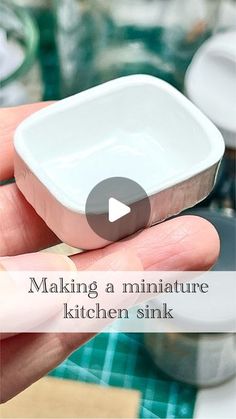 a person holding a small white container with the words making a miniature kitchen sink on it