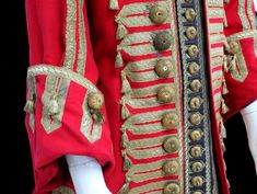 a red coat with gold trim and buttons