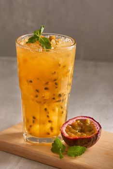 a glass filled with liquid next to a cut up fruit