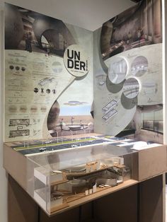 a display case with an architectural model on the front and back wall, along with information about different types of buildings