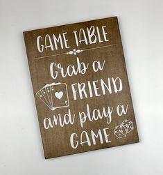 a wooden sign that says game table, crapa a friend and play a game