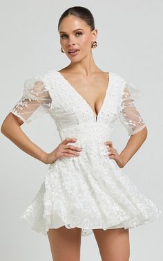 Pamela Mini Dress - Embroidered Plunge Tiered Dress in White | Showpo USA Tiered Lace Bodice Wedding Dress, Tiered Wedding Dress With Lace Bodice, Elegant Tiered Mini Dress With Fitted Bodice, White V-neck Dress With Fitted Bodice, White Feminine Mini Dress For Wedding Guest, White Fitted Dress With Lace Bodice, White Lace Bodice Fitted Dress, White Dress With Lace Bodice For Brunch, White Lace Bodice Dress For Brunch