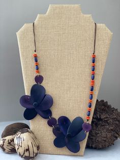 Handmade in Ecuador Necklace Length: 27 Inches Material: Tagua Nut Gold Handmade Clasp Due to this item being handmade and the nature of the Tagua Nut the size and the color may vary from piece to piece Adjustable Blue Fair Trade Necklace, Bohemian Beach Jewelry With Handmade Flowers, Blue Flower-shaped Bohemian Necklace, Bohemian Handmade Flower Jewelry For Beach, Blue Bohemian Flower Necklace, Bohemian Blue Jewelry With Handmade Flowers, Adjustable Blue Nature-inspired Necklace, Blue Adjustable Nature-inspired Necklace, Handmade Flowers Adjustable Beach Jewelry