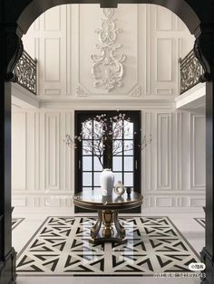 an elegant foyer with white walls and black trim