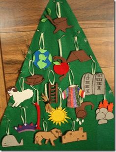 a christmas tree made out of felt with animals and other things on it's side