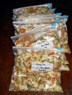 five bags of food sitting on top of a wooden table