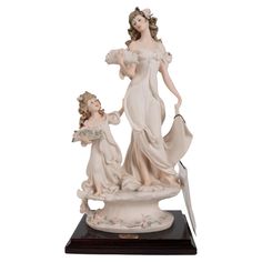 a figurine of a woman and child holding hands with a knife in their hand