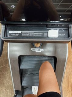 a person standing on a treadmill with their feet propped against the machine's screen